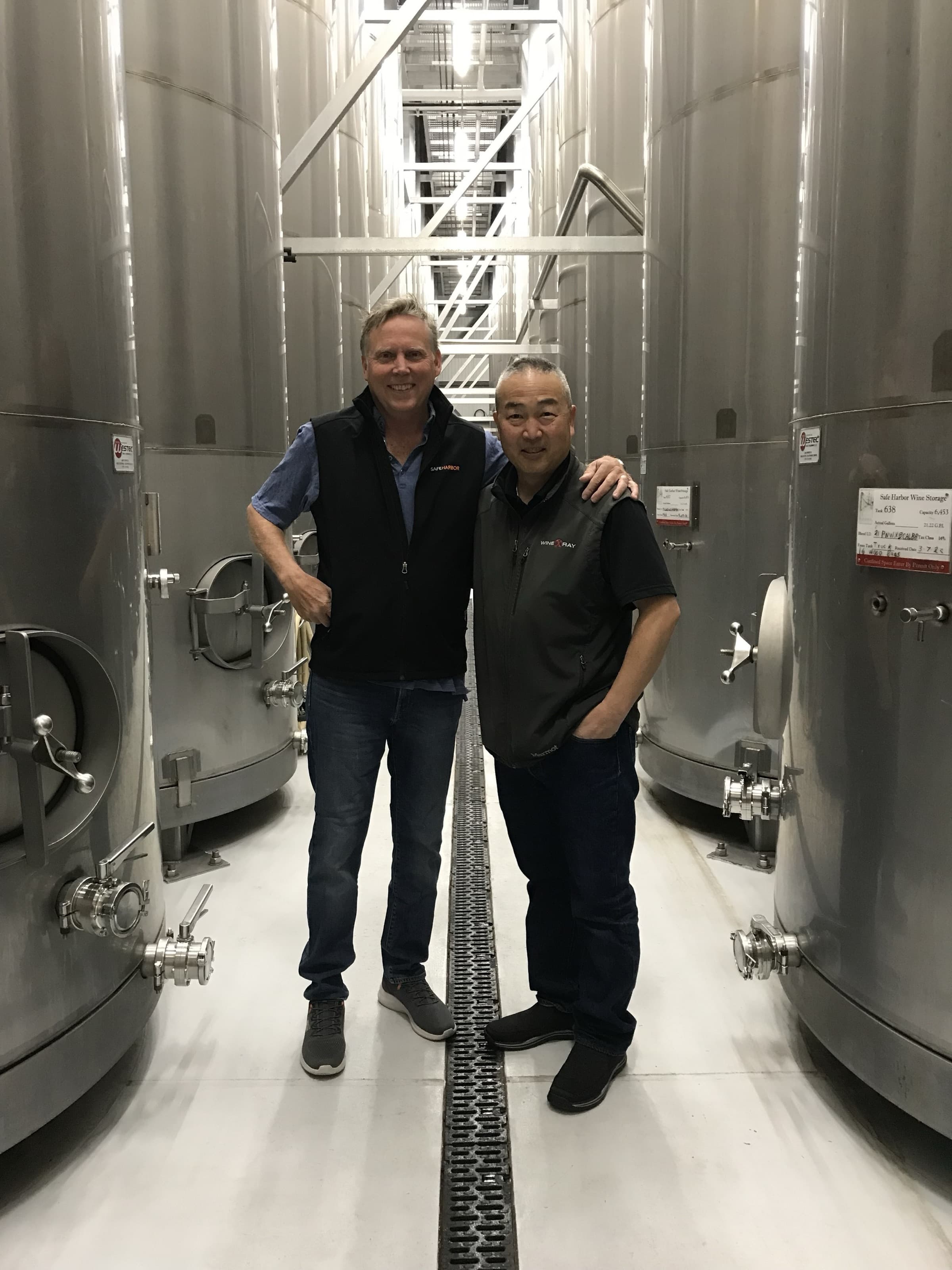 Hayashi with Scott McLeod between stainless steel tanks
